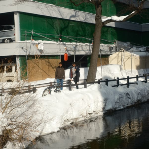 Two men standing in front of a building.