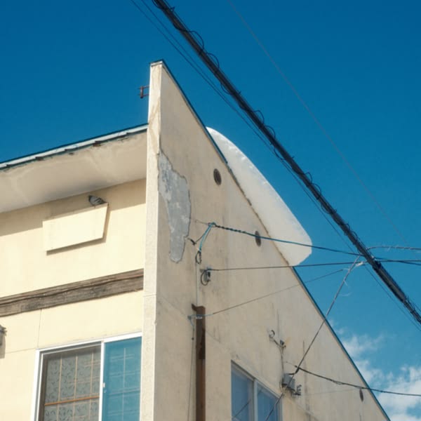 A building with a white roof and a blue sky.