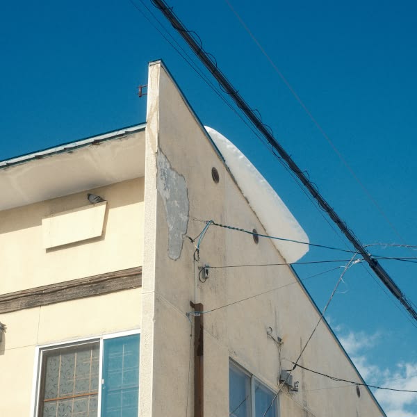 A building with a white roof and a blue sky.