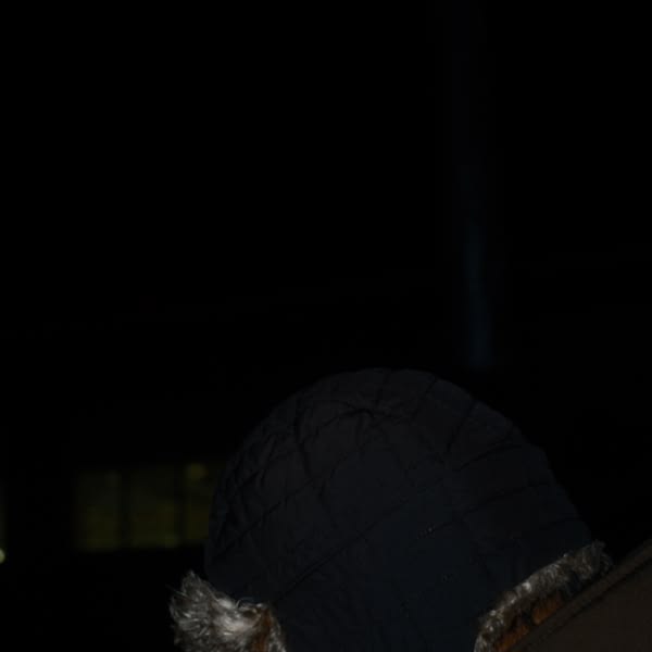 A person wearing a black hat.