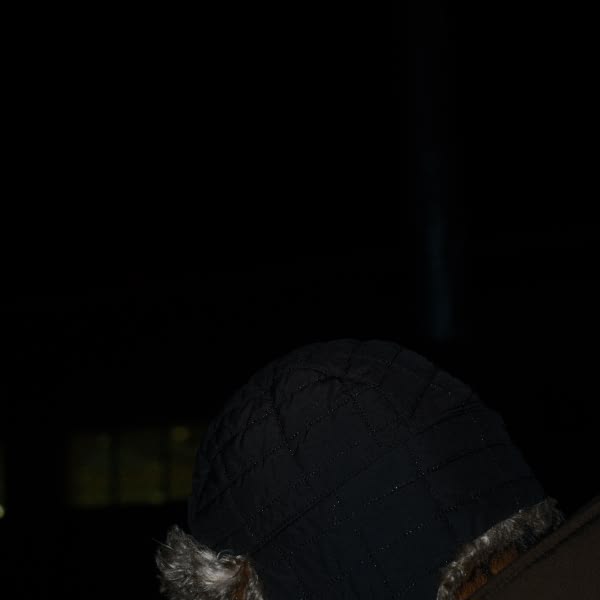 A person wearing a black hat.
