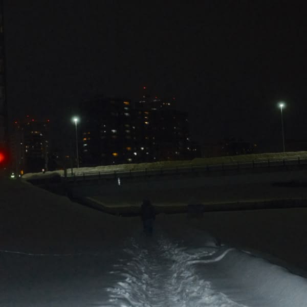 A man walking on a snowy path.