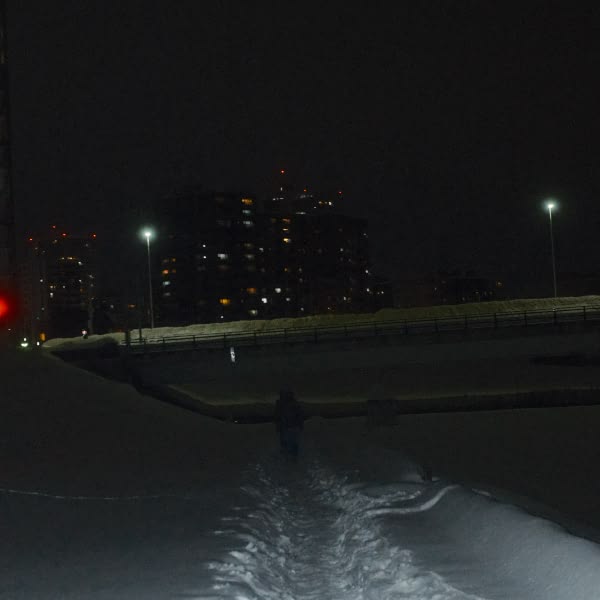 A man walking on a snowy path.