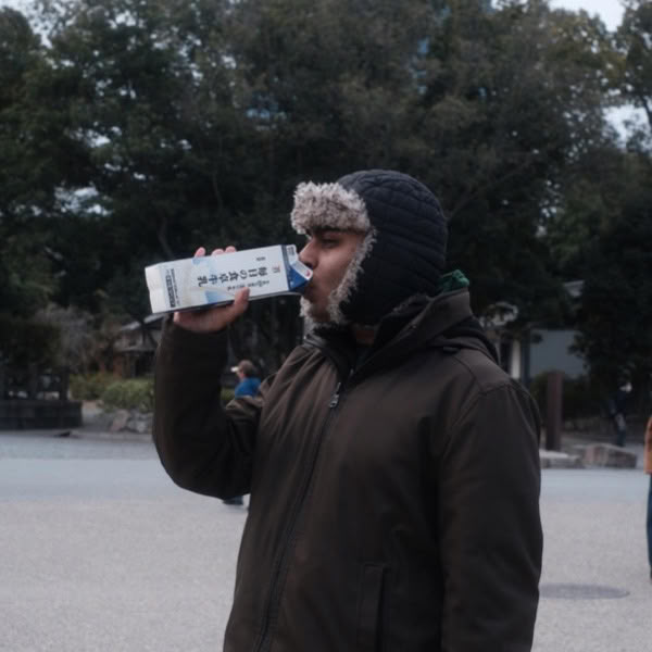 A man drinking milk from a carton.
