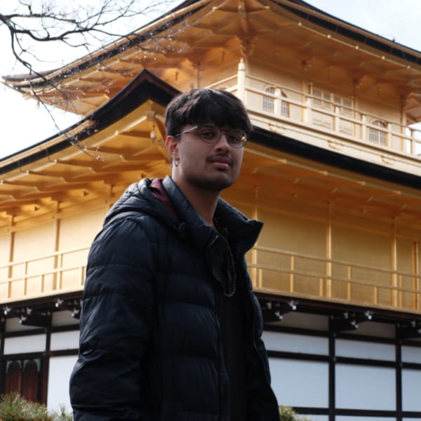 A man standing in front of a building.