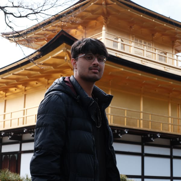 A man standing in front of a building.