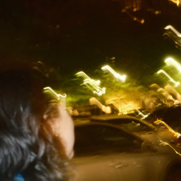 A woman looking at a car.