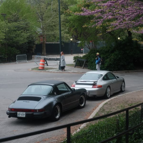 Two cars parked in a parking lot.
