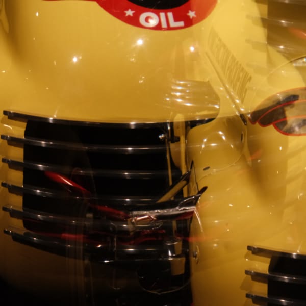 A yellow car with a red seat.