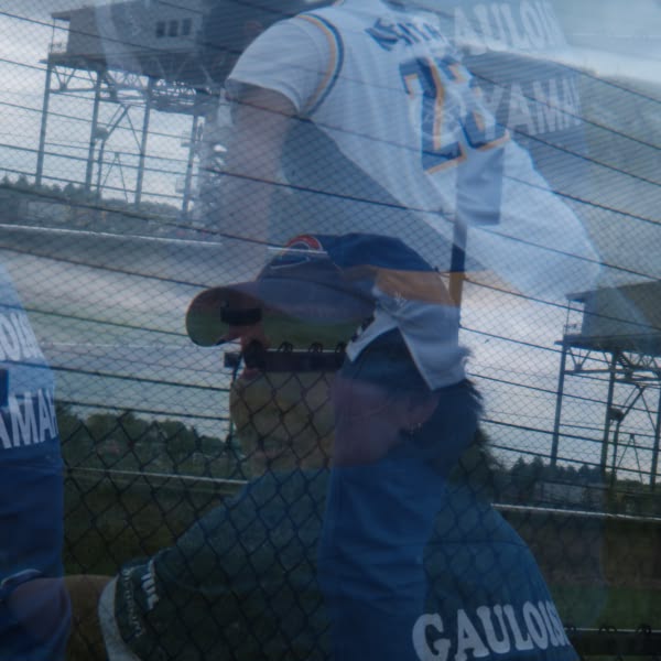 A man wearing a blue baseball jersey.