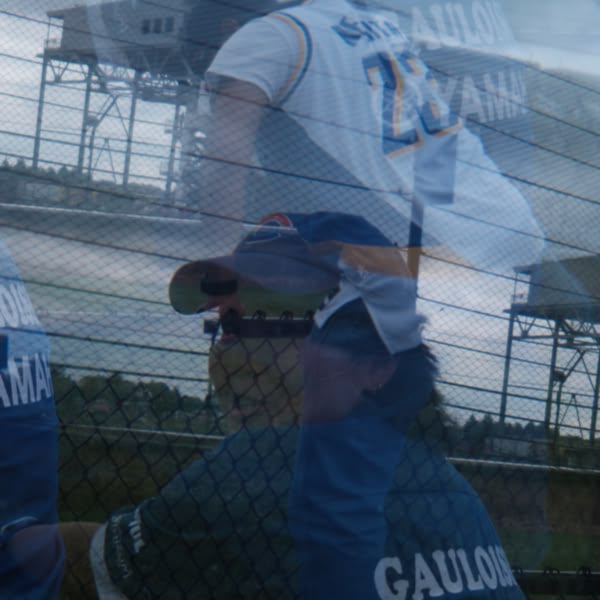A man wearing a blue baseball jersey.