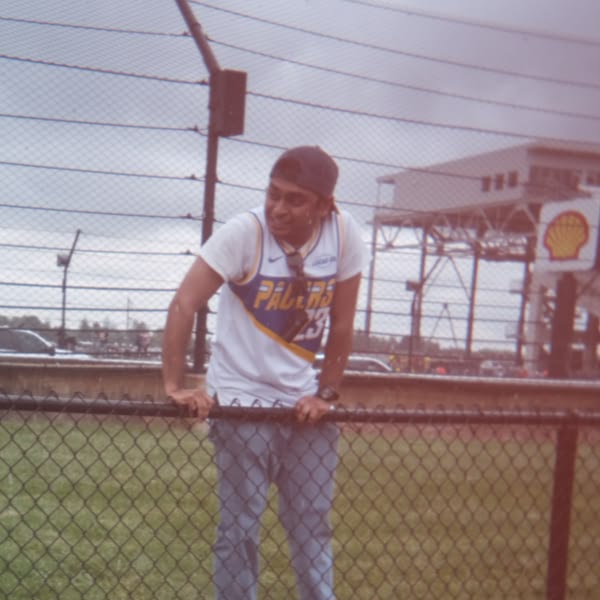 A man wearing a white shirt and a blue cap.