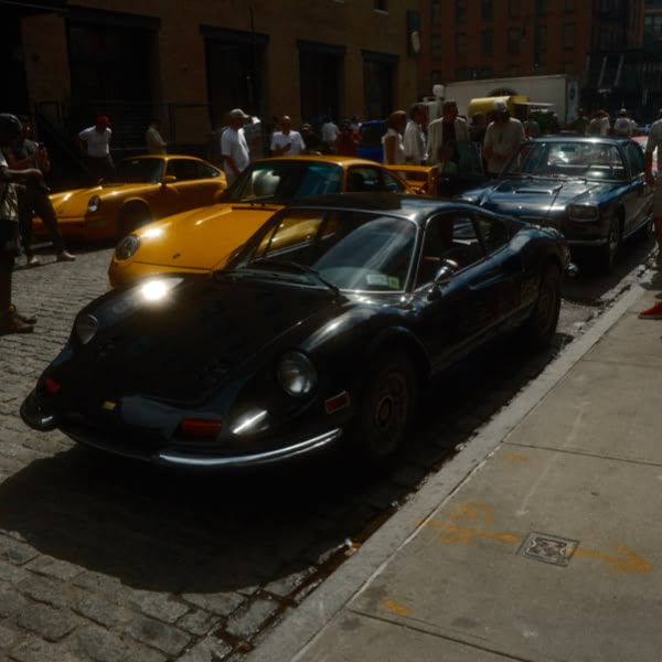 A black sports car parked on the side of a street.