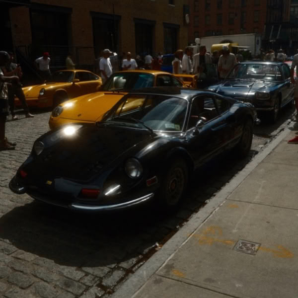 A black sports car parked on the side of a street.