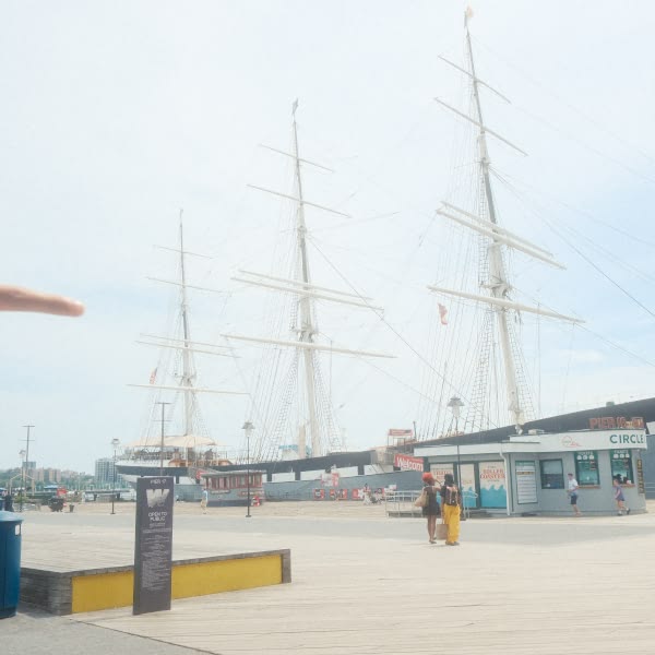 A wooden pier with a sign in front of it.