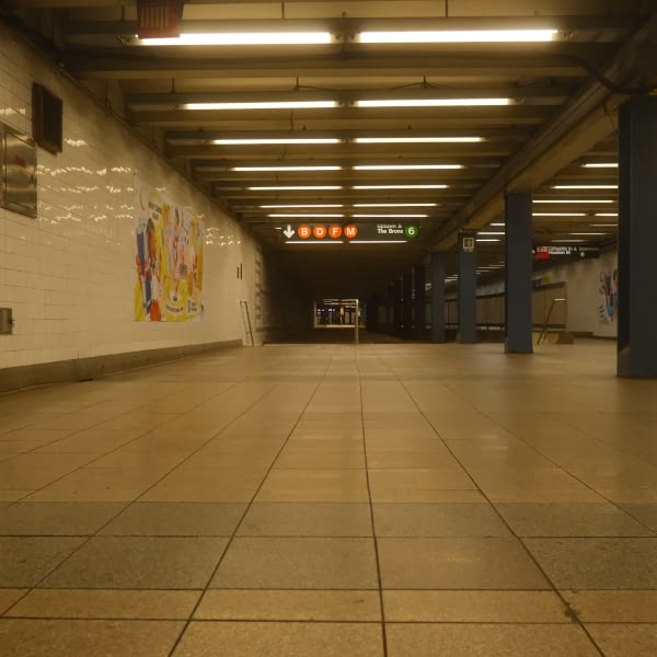 A subway station with a sign that says "1" and "2" on it.