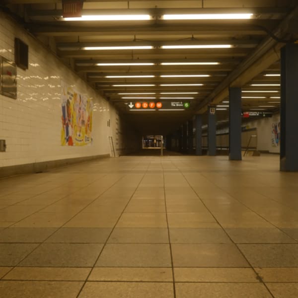 A subway station with a sign that says "1" and "2" on it.